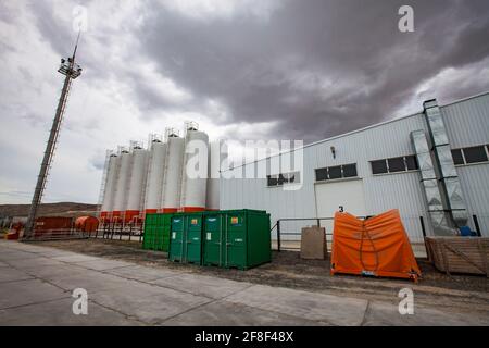 Mangystau, Kazakhstan - May 19 2012: Bautino bay. Loading terminal on Caspian sea. Storage tanks Grey storm clouds. Wide-angle view. Stock Photo