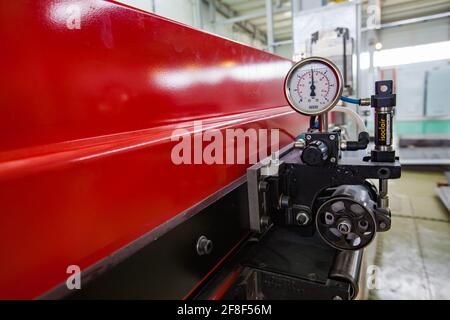 Aktau, Kazakhstan. Electric stamping machine close up photo. Manometer gauge. Production of special electric equipment. RIG Ltd. Stock Photo