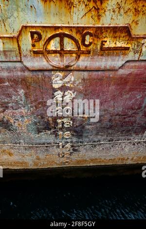 Aged rusted ship side. Barge in cargo terminal. Close up photo Stock Photo