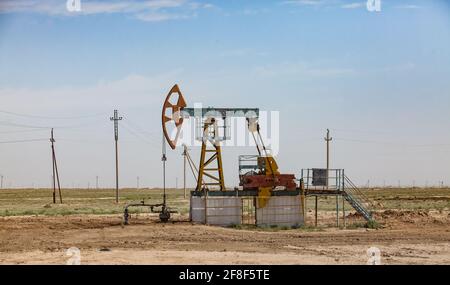 Oil pumping jack in desert. Zhanaozen, Kazakhstan. Stock Photo