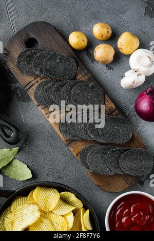 Cheese and chive potato crisp snack, with dipping sauces , on gray stone background, top view flat lay Stock Photo