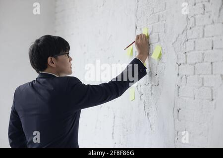 Portrait of businessmen post-it wall brick, Creative employee working in office Stock Photo