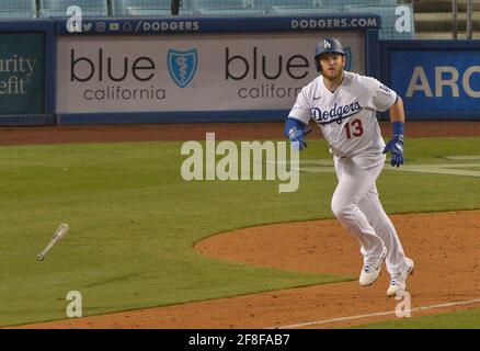 Los Angeles, United States. 14th Apr, 2021. Los Angeles Dodgers' first baseman Max Muncy flings his bat after hitting solo home run off Colorado Rockies relief pitcher Robert Stephenson during the sixth inning at Dodger Stadium in Los Angeles on Tuesday, April 13, 2021. The Dodgers defeated the Rockies 7-0. Photo by Jim Ruymen/UPI Credit: UPI/Alamy Live News Stock Photo