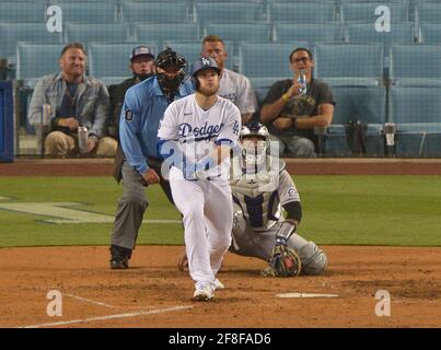 Los Angeles, United States. 14th Apr, 2021. Los Angeles Dodgers' first baseman Max Muncy watches his solo home run off Colorado Rockies relief pitcher Robert Stephenson go over the wall during the sixth inning at Dodger Stadium in Los Angeles on Tuesday, April 13, 2021. The Dodgers defeated the Rockies 7-0. Photo by Jim Ruymen/UPI Credit: UPI/Alamy Live News Stock Photo