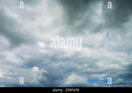 Dramatic real sky with grey clouds before storm. The real sky background, high resolution. Stock Photo
