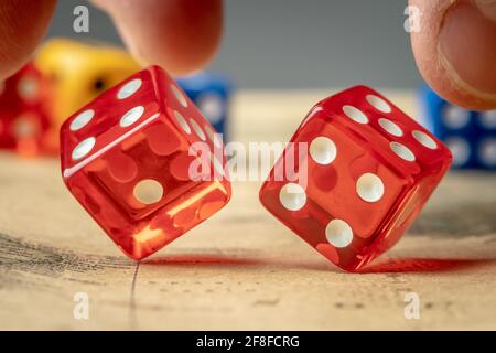 The hand is throwing the red dices on the map. The concept of board games and a lucky chance to win Stock Photo