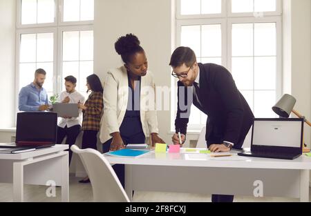 African american employee working with caucasian project manager in office Stock Photo