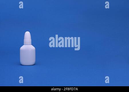 Nasal spray close-up on a blue background. mock up Stock Photo