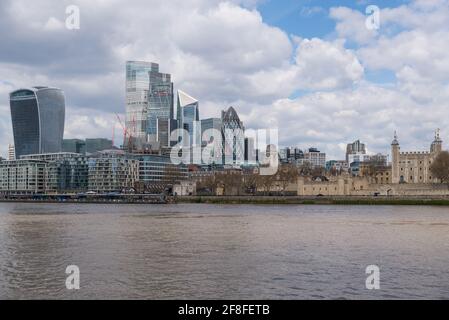 City of London skyline with modern skyscraper buildings as seen from the south side of the Thames and including the historic Tower of London.