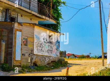 Old building facade, eroded by time and vandalised with graffitty at Vama Veche, Romania, July 2020 Stock Photo