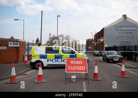The scene at the industrial premises on Western Road near Birmingham's City Hospital where a murder investigation has been launched after a fatal shooting. A 31-year-old man was found dead on Tuesday while another male has been taken to hospital with serious injuries. Picture date: Wednesday April 14, 2021. Stock Photo