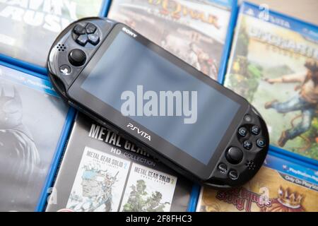 Sony Playstation Vita on top of game cases. Stock Photo