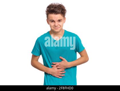 Upset unhappy young man holding his abdomen with both hands, suffering from bellyache, isolated on white background Stock Photo