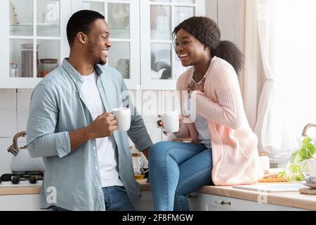 Joyful Black Lovers Having Fun Together While Drinking Coffee In Kitchen Stock Photo