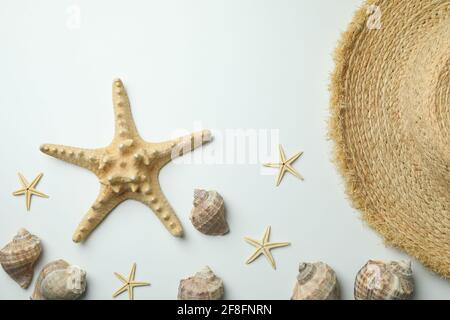 Straw hat and seashells on white background Stock Photo