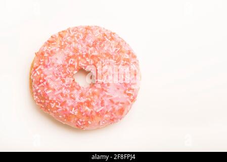 Colourful iced ring doughnuts with sprinkles. Stock Photo