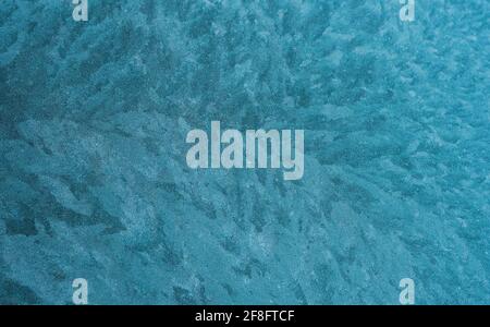 Ice crystals formed on glass. Blue. Stock Photo