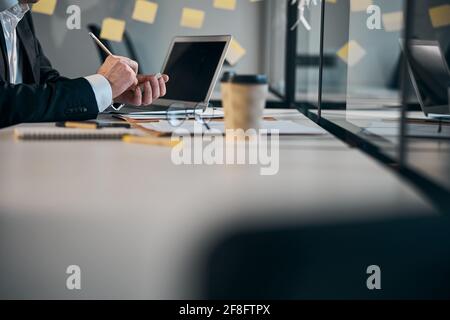 Male worker hands writing on sticky notes in office Stock Photo