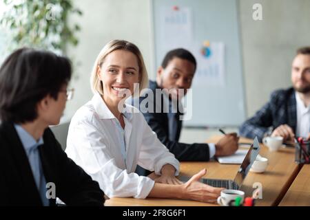 Successful Businesswoman On Corporate Meeting Smiling To Asian Businessman Indoor Stock Photo