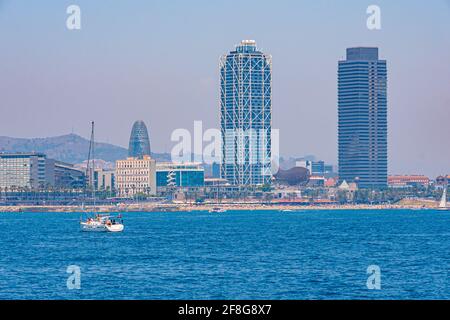 Twin towers standing over Barceloneta beach in Barcelona, Spain Stock Photo