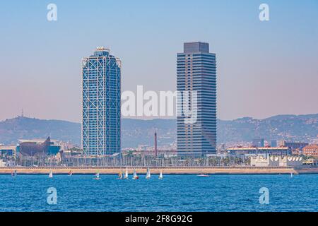 Twin towers standing over Barceloneta beach in Barcelona, Spain Stock Photo