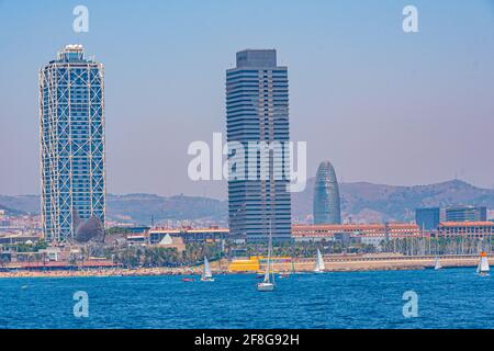 Twin towers standing over Barceloneta beach in Barcelona, Spain Stock Photo