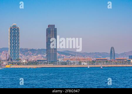 Twin towers standing over Barceloneta beach in Barcelona, Spain Stock Photo