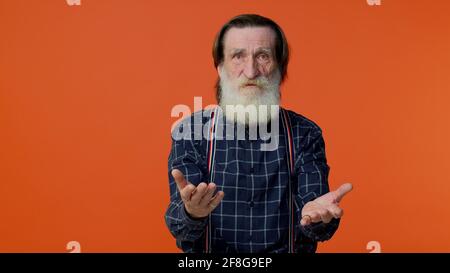 Elderly man raising hands in indignant expression, asking why, what reason of failure, irritation Stock Photo