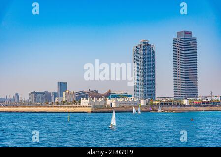 Twin towers standing over Barceloneta beach in Barcelona, Spain Stock Photo