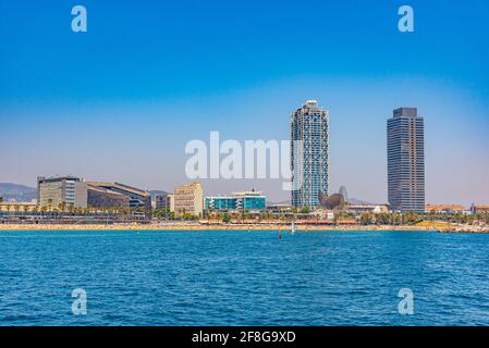 Twin towers standing over Barceloneta beach in Barcelona, Spain Stock Photo