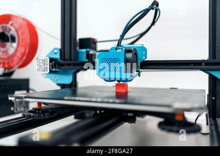 Stock photo of modern 3d printer printing cool red design. Stock Photo