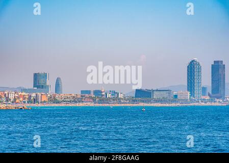 Twin towers standing over Barceloneta beach in Barcelona, Spain Stock Photo