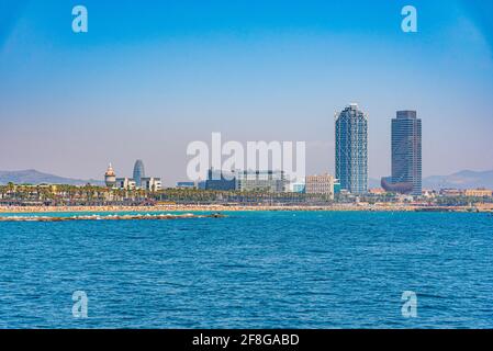 Twin towers standing over Barceloneta beach in Barcelona, Spain Stock Photo