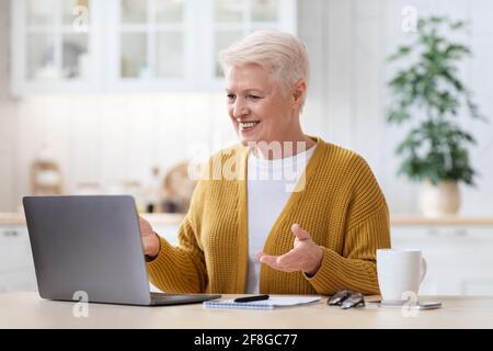 Positive granny having video conference with family Stock Photo