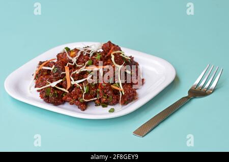 Paneer Tikka Kabab in red sauce - is an Indian dish made from chunks of cottage cheese marinated in spices , chilli Paneer Kabab, Spicy cottage cheese Stock Photo