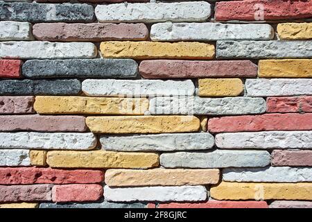 Wall of colored homemade bricks as texture for background. Stock Photo