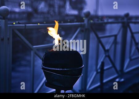 Burning oil lamp by the water in relaxed mood in Blåvand Stock Photo