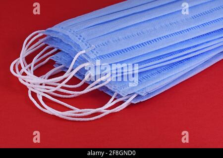 Surgical mask with rubber ear straps Typical 3-ply surgical mask mouth and nose Procedure mask from bacteria, corona virus protection , Stock Photo
