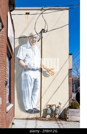 A quiet sidewalk during the COVID lockdown gives a rare unobstructed view of this mural for a city diner. Stock Photo
