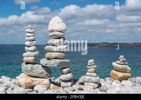 Pile of stones on a beach, ocean background in Brittany, France Stock Photo