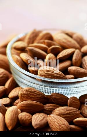 Almonds in bowl, Group of almond nuts isolated on white background Depth of field Stock Photo