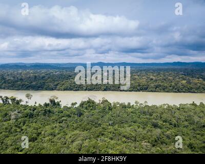 Beautiful drone aerial view of Amazon rainforest trees landscape and Jamanxim river on cloudy day in Para, Brazil. Nature, ecology, environment. Stock Photo