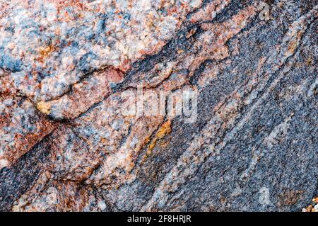 Spots and stripes are gray-red background. Textured red background. The texture of the sea stone is red-brown. Stock Photo