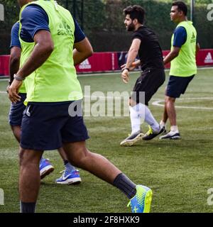 New Delhi, India - July 19 2019: Footballers of local football team during game in regional Derby championship on a bad football pitch. Hot moment of Stock Photo