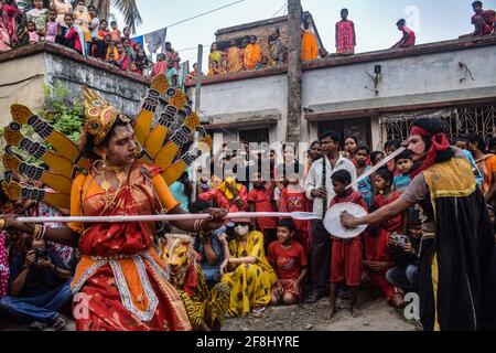 Bardhaman, India. 13th Apr, 2021. Cosplayers are seen performing the Hindu mythological story during Gajan festival. Gajan is a Hindu festival celebrated mostly in West Bengal as well as southern part of Bangladesh. The festival is associated to the devotion of Lord Shiva. People celebrate by performing rituals such as face painting and cosplaying. Devotees dress up as Hindu mythological characters and perform various mythological stories door to door. (Photo by Tamal Shee/SOPA Images/Sipa USA) Credit: Sipa USA/Alamy Live News Stock Photo