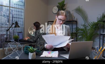 Displeased upset businesswoman accountant throwing documents after analyzing financial office papers Stock Photo