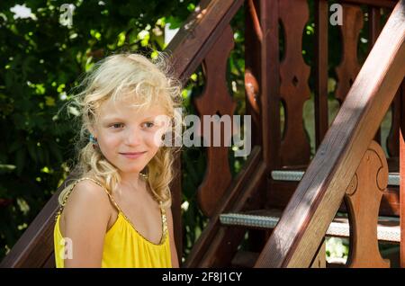 little blond girl in yellow dress portrait Stock Photo