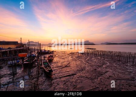 Beautiful sky in the morning during sunrise and fisherman longtail boats Stock Photo