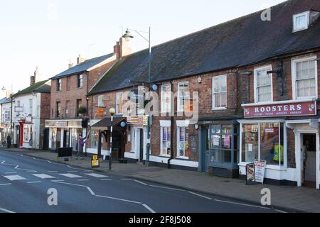 Shops on the side of a road in Buckingham, Buckinghamshire in the UK Stock Photo