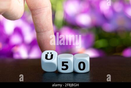 Dice form the German expression 'UE 50' (above 50 years old) as symbol for people older than 50 years. Stock Photo